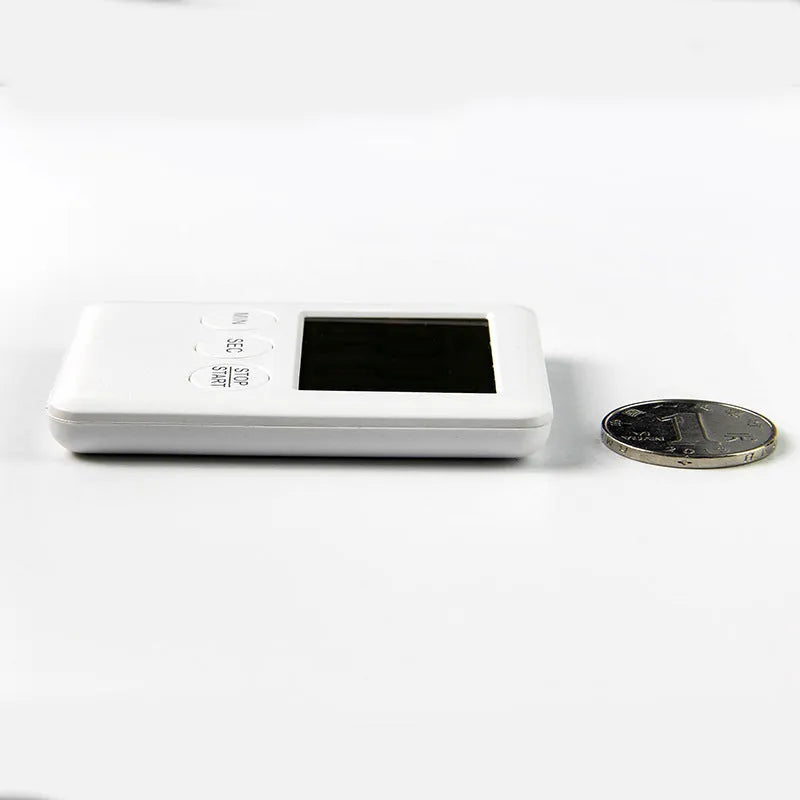 Black and white kitchen timer with magnetic back showing count-up and countdown display