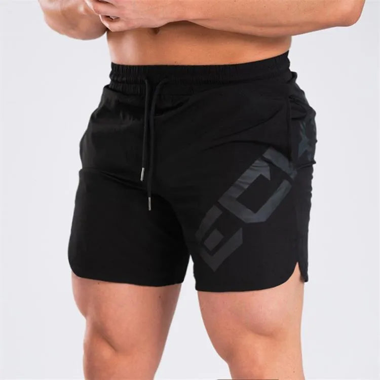 Man wearing black knee-length nylon running shorts during summer training.