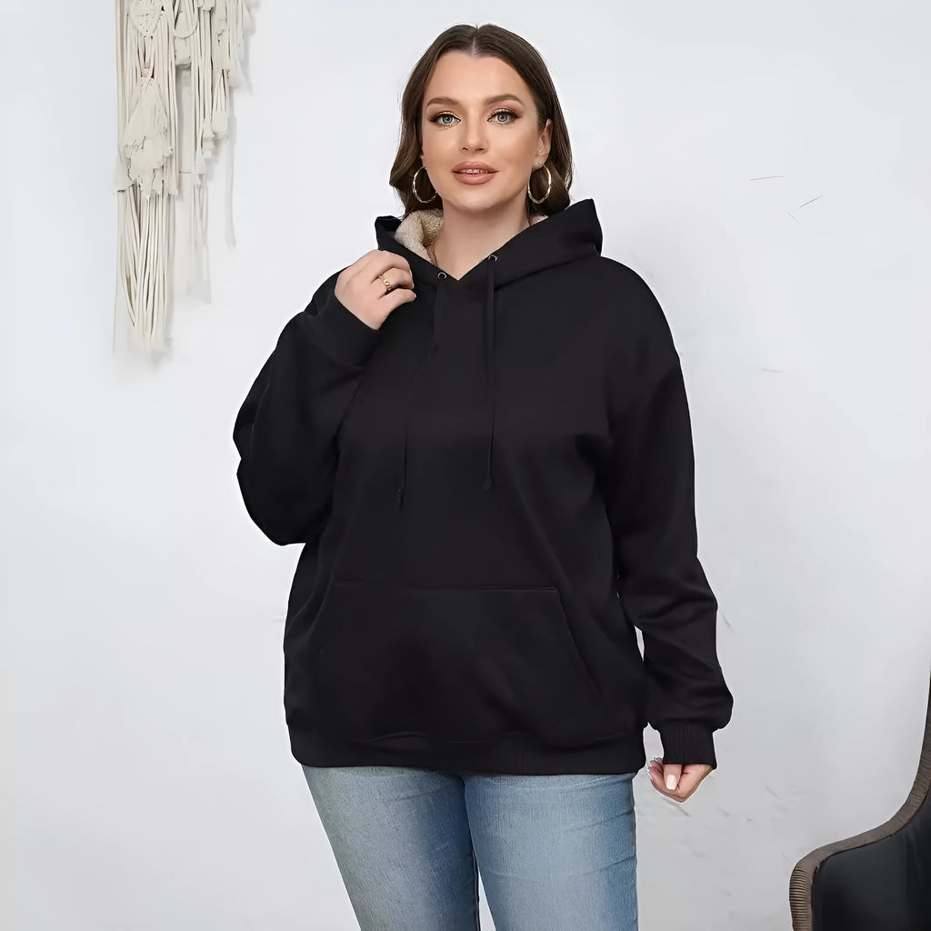 A women's loose fit hooded sweater in thick grey polyester with side pockets and long sleeves.