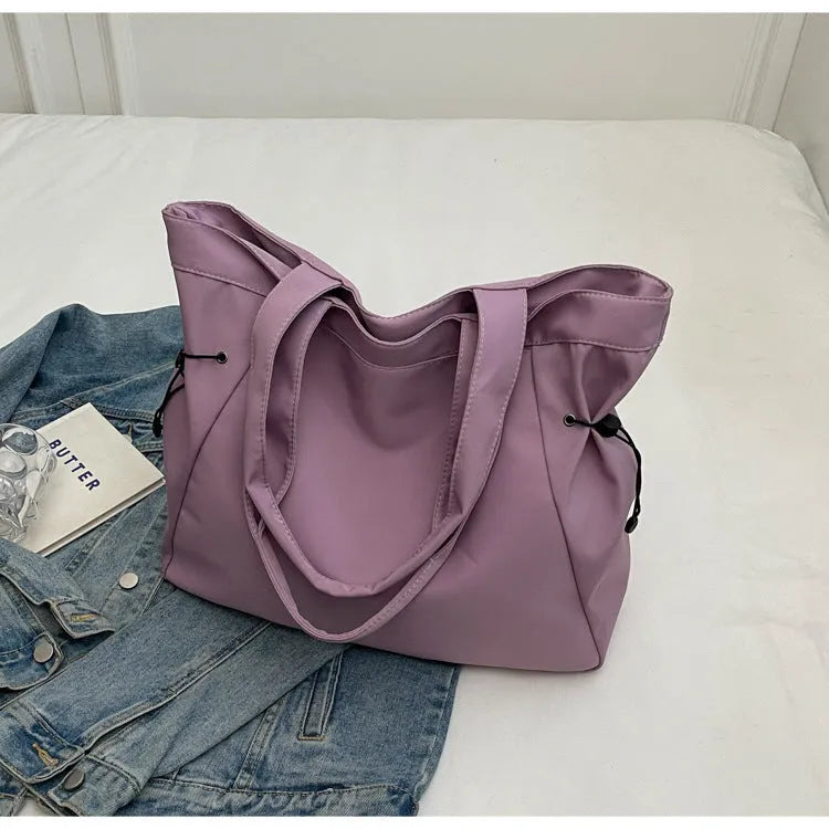 Soft Oxford cloth commuter tote bag in a street style, shown in a folded position.