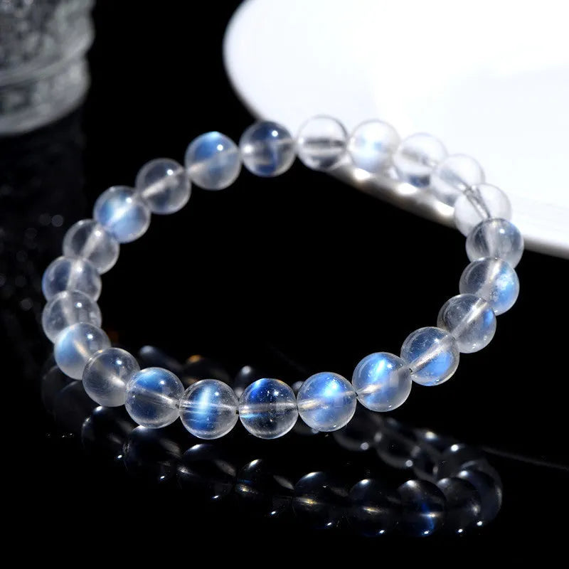 Natural cream body crystal bracelet with spherical beads on a wrist, showing minimalist unisex design.