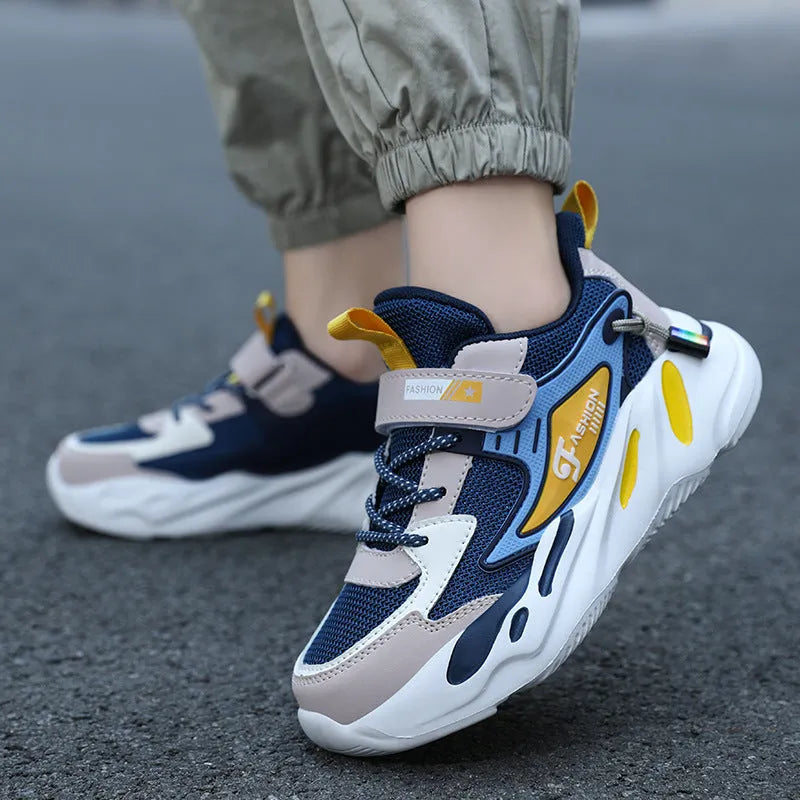 Boys' dark blue and black sports running shoes with velcro strap and mesh upper.
