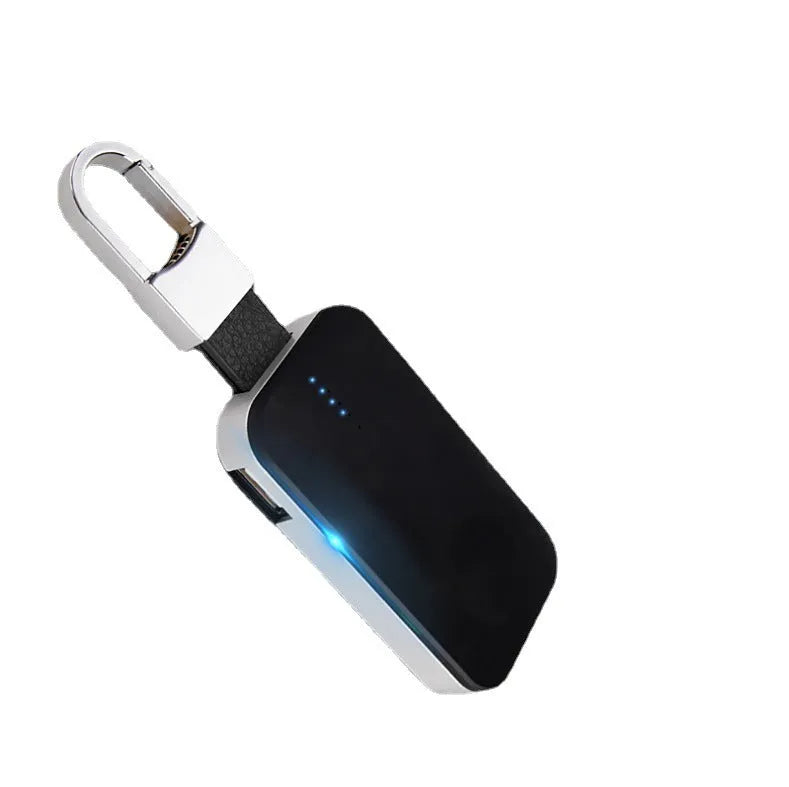 Black Apple Watch keychain wireless power bank with 1000mAh battery next to an Apple Watch.
