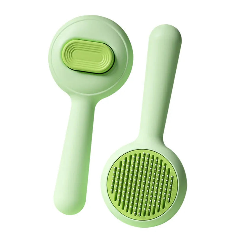Green pet grooming brush with stainless steel comb pins and non-slip handle for cats and small dogs