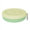 Portable dog feeding bowl with snack compartment lid in light green colour