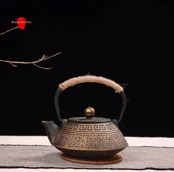 Japanese cast iron teapot with decorative pattern and enamel interior, 0.9L capacity