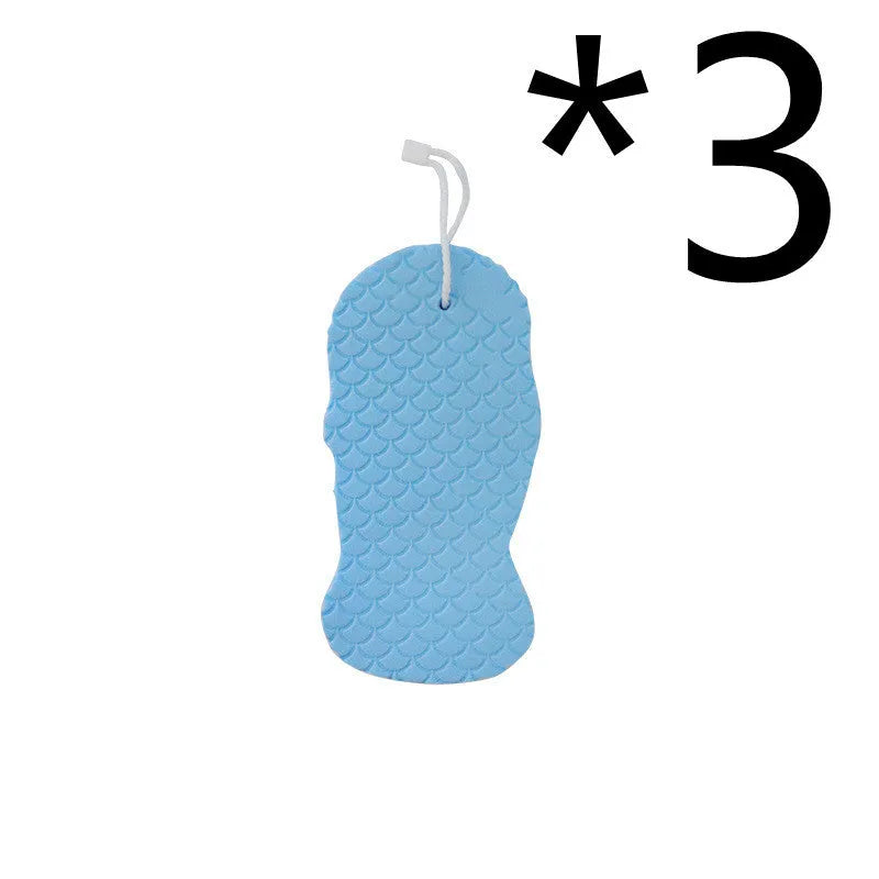 White 3D fish scale pattern bath sponge ball on a bathroom surface