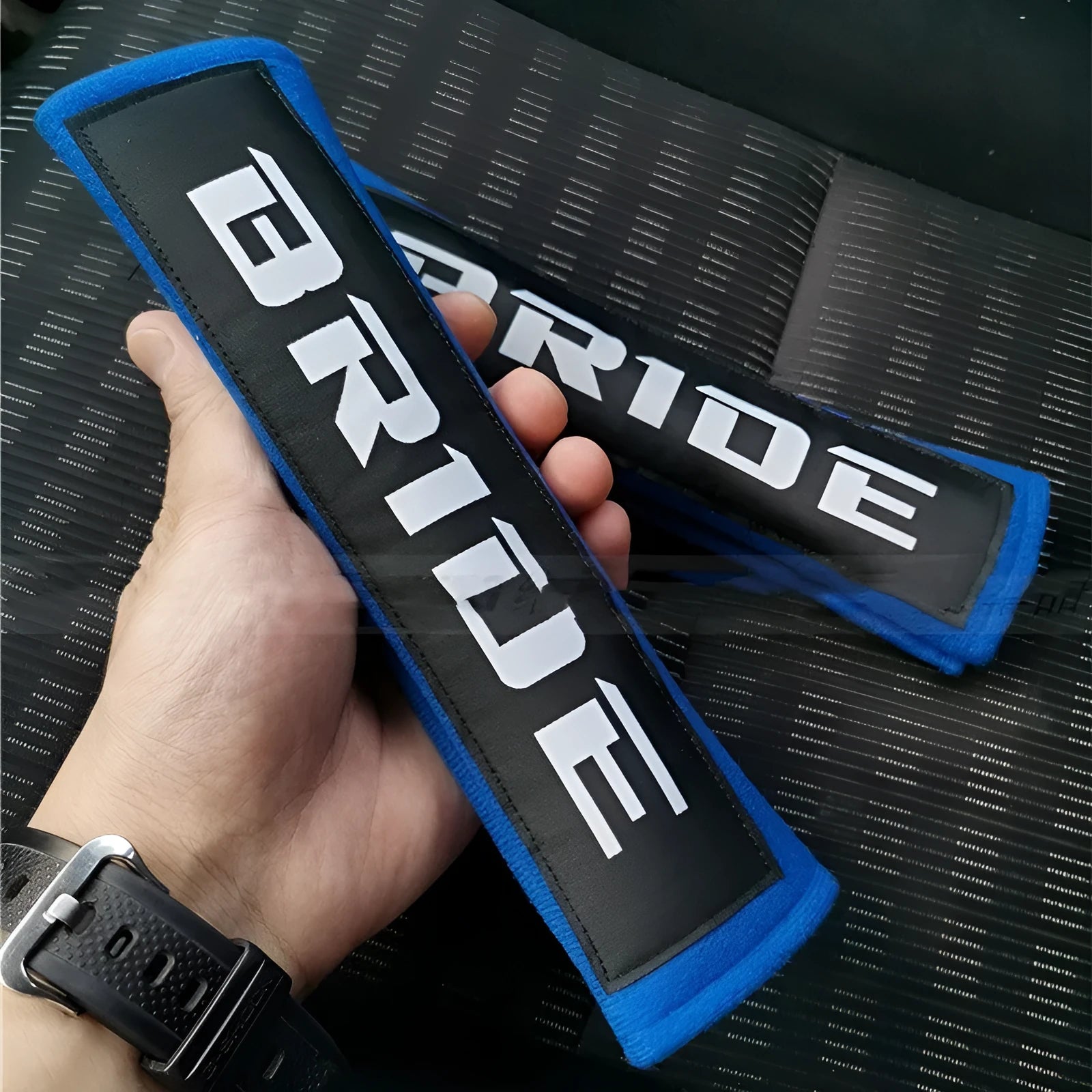 Pair of black car seat belt shoulder pads with embroidery, showing dimensions.