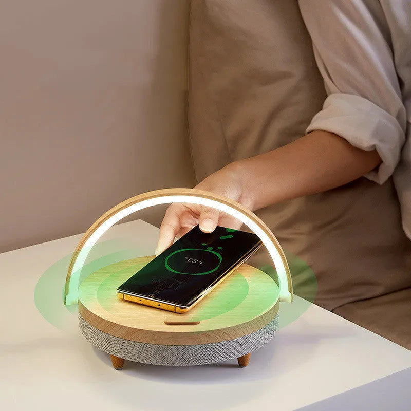 Marble pattern wireless charging LED night light with Bluetooth speaker and integrated mobile phone holder.