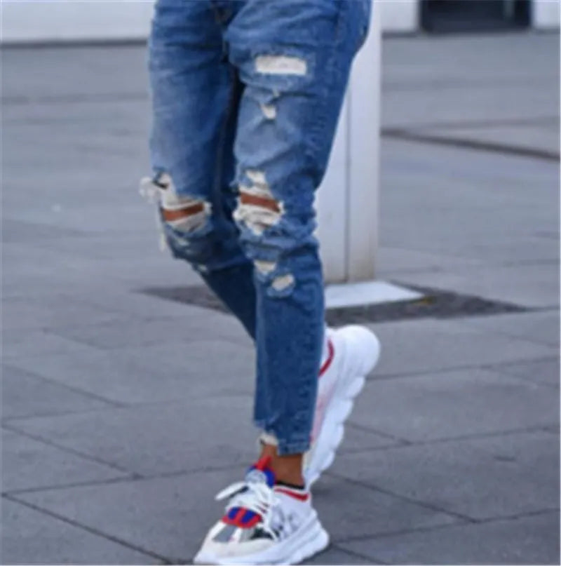Men's deep blue jeans with knee hole distressed detailing on cotton fabric