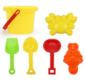 Plastic beach bucket set in sand with bucket and coloured accessories