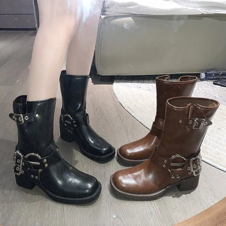 Black and brown women's platform boots with buckle details on the calf.