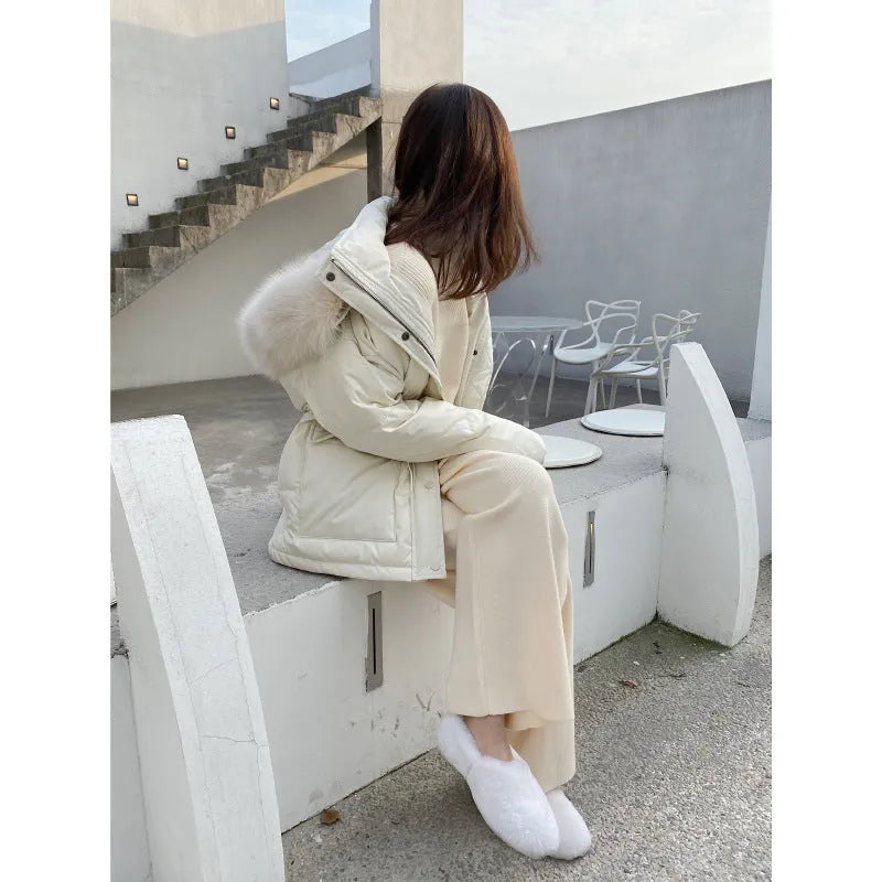 Women's cream white thick knitted wide-leg trousers with a high waist and drooping hem laid flat.