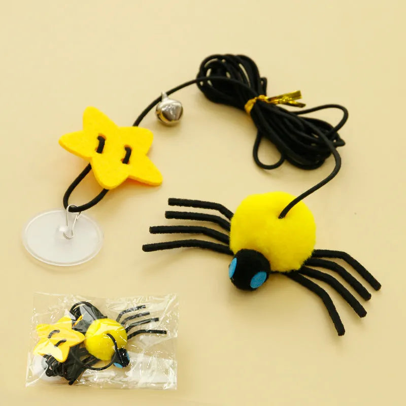 Hanging elastic rope cat toy with feather, bell and spider elements on playing stick in red colour