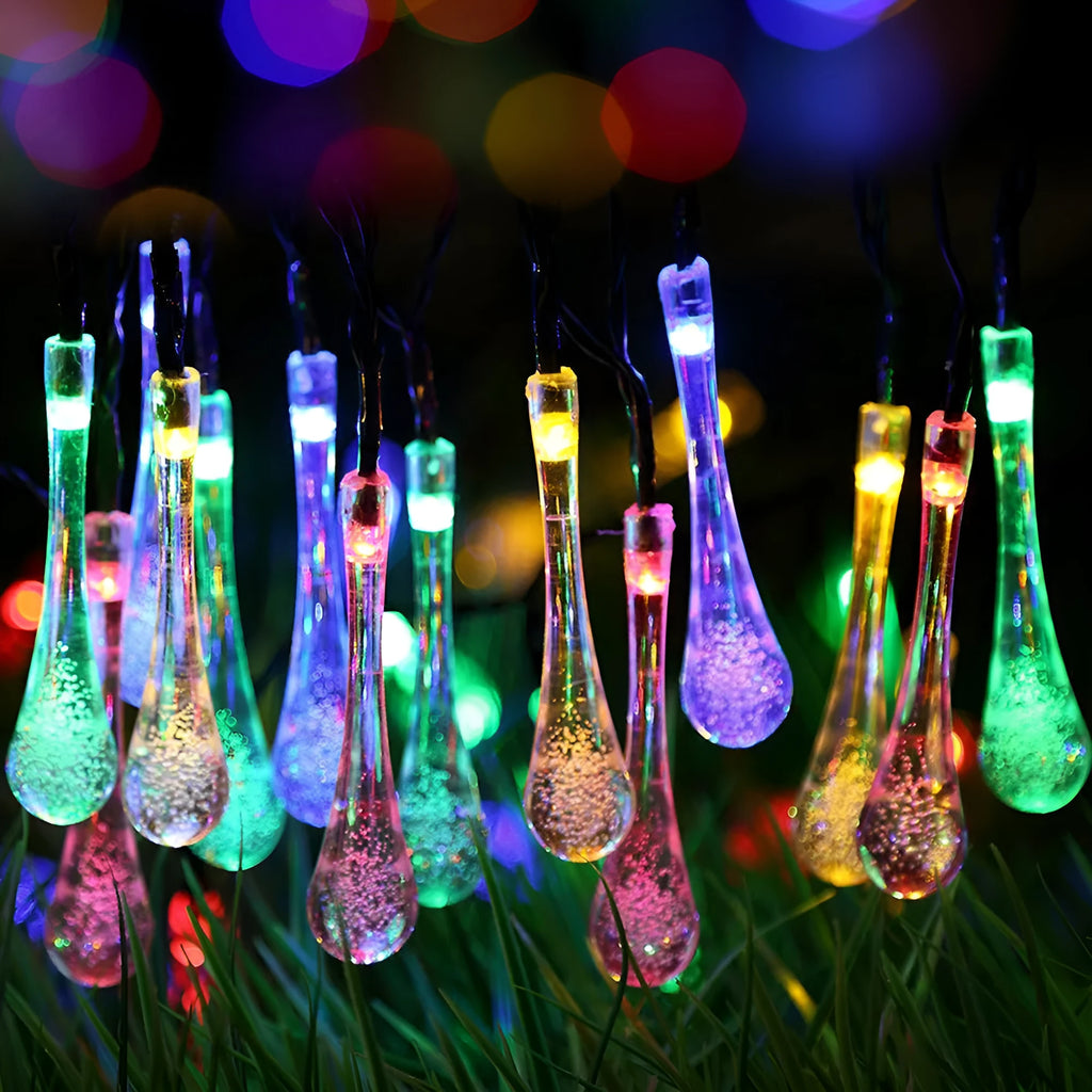 Solar-powered outdoor water drop LED string lights with warm white illumination on 6.5 metre waterproof cord