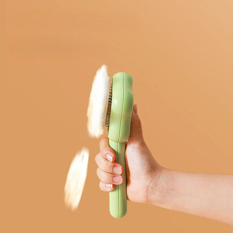 Self-cleaning stainless steel cat comb in green colour measuring 20cm long by 9.5cm wide