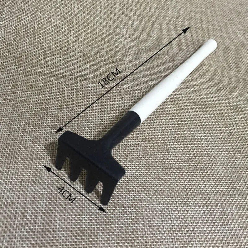 Succulent gardening tool set showing mini shovel, watering can, tweezers, and small scissors on a table.