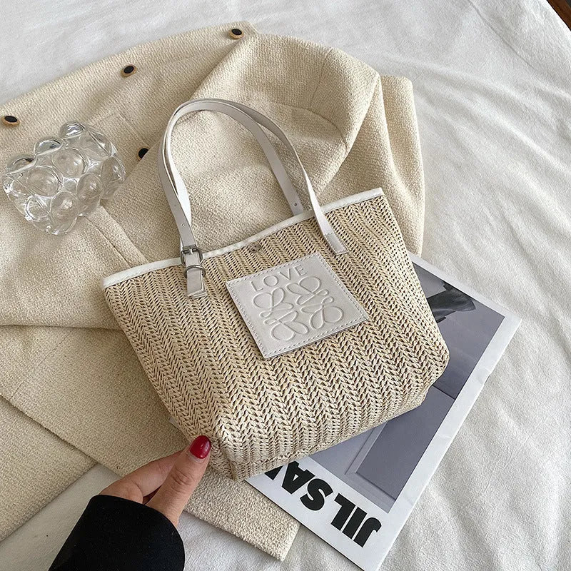 Straw woven women's shoulder bag in black showing European retro style with three-dimensional pocket