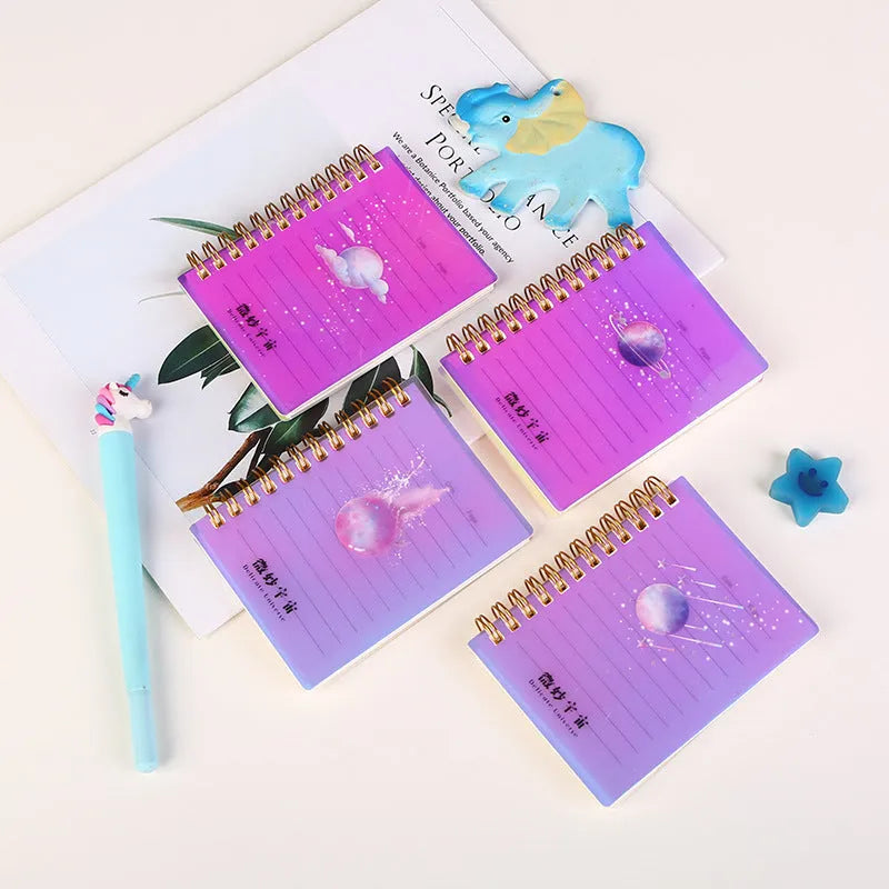 Pack of four rollover coil A7 pocket notebooks showing constellation, sakura, ocean, and universe cover designs