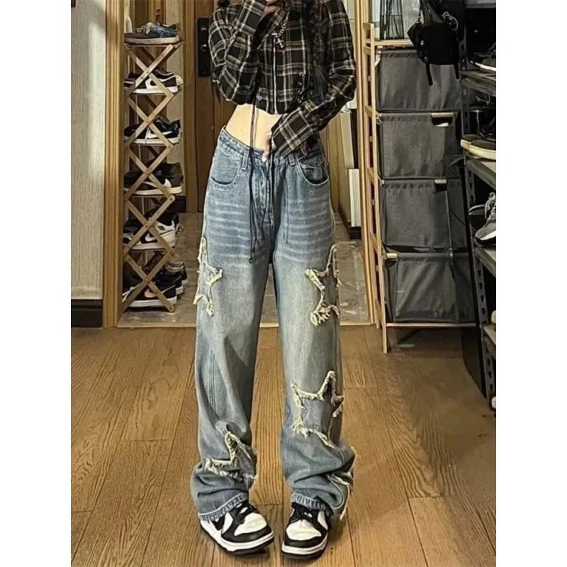 Blue high-waisted wide-leg denim trousers on a hanger, showing the straight-leg cut and front view.