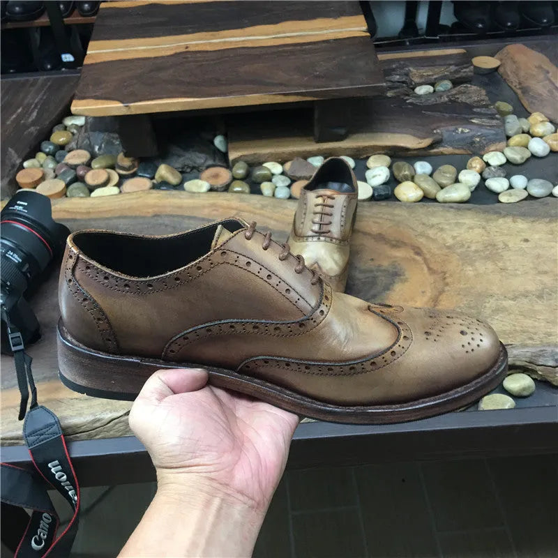 Men's light brown vintage distressed leather casual shoes with engraved detailing and round toe.