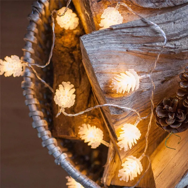Battery-powered LED pine cone light string in warm white with plastic pine cone shells