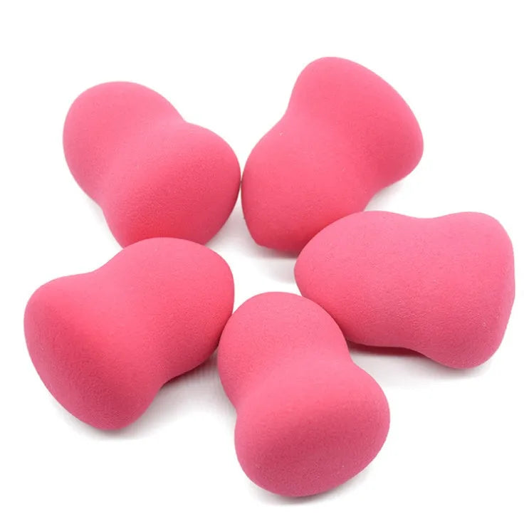 Pink non-latex makeup foundation sponge shown next to a ruler showing 4 cm width and 5.6 cm height