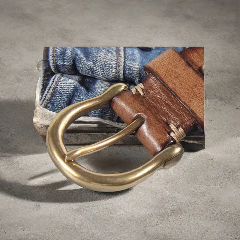 Men's brown casual leather belt with copper pin buckle on a jeans background.