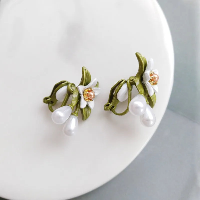 Women's flower ear clip earrings with sterling silver needle flowers and contrast colour alloy metal design