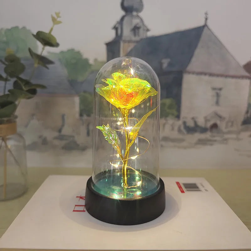 Small plastic night lamp with glass cover and flower decoration on black base