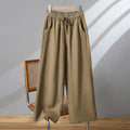 Women's apricot straight-leg casual trousers with elastic drawstring waist laid flat.