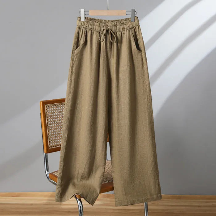 Women's apricot straight-leg casual trousers with elastic drawstring waist laid flat.