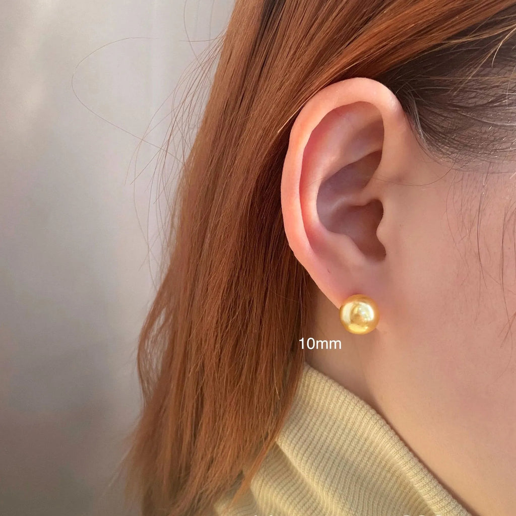 Women's large pearl stud earrings with an eight-pointed star geometric setting in sterling silver.