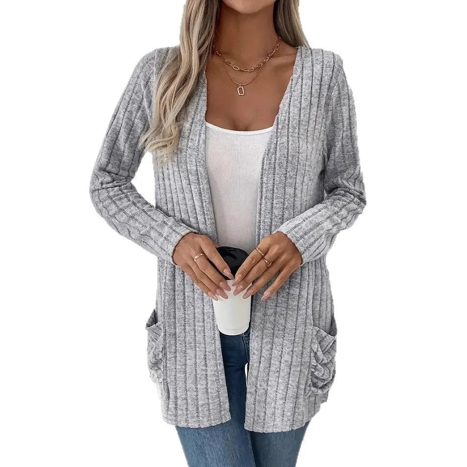 Solid colour long sleeve cardigan with front pockets in a loose fit, shown in grey.