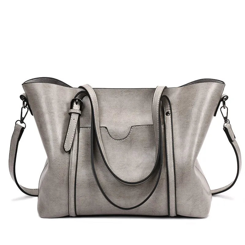 Retro messenger bag for women showing coffee colour option with A4 magazine for scale