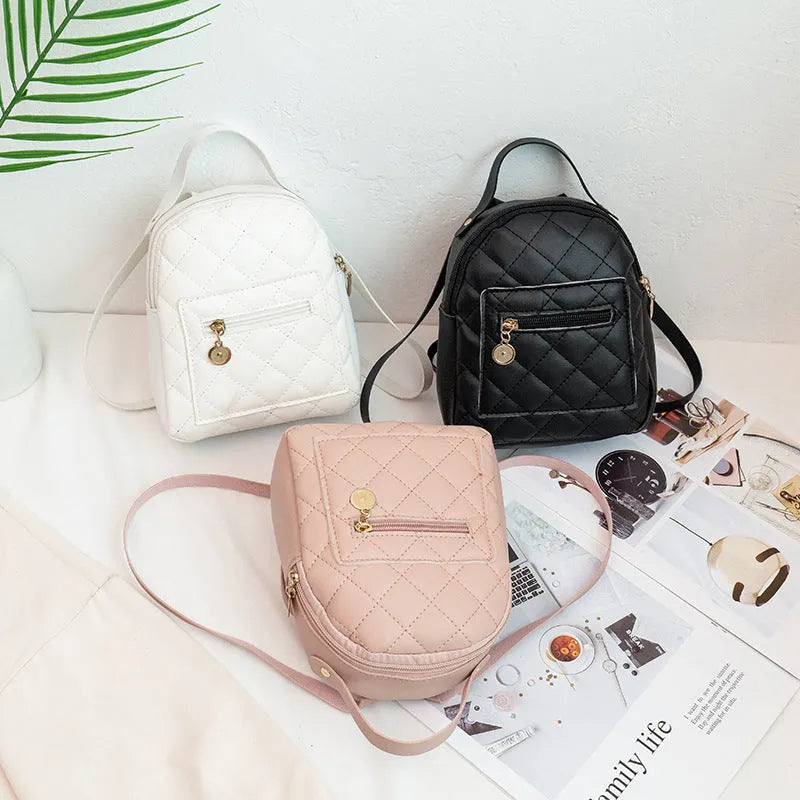 Girls' hard shell backpack with embroidery in black, pink, or white colours showing square shape and sandwich pocket