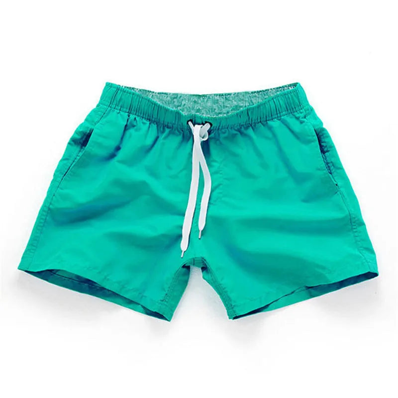 Men's straight-leg beach shorts in polyester fabric shown in a solid colour, laid flat.