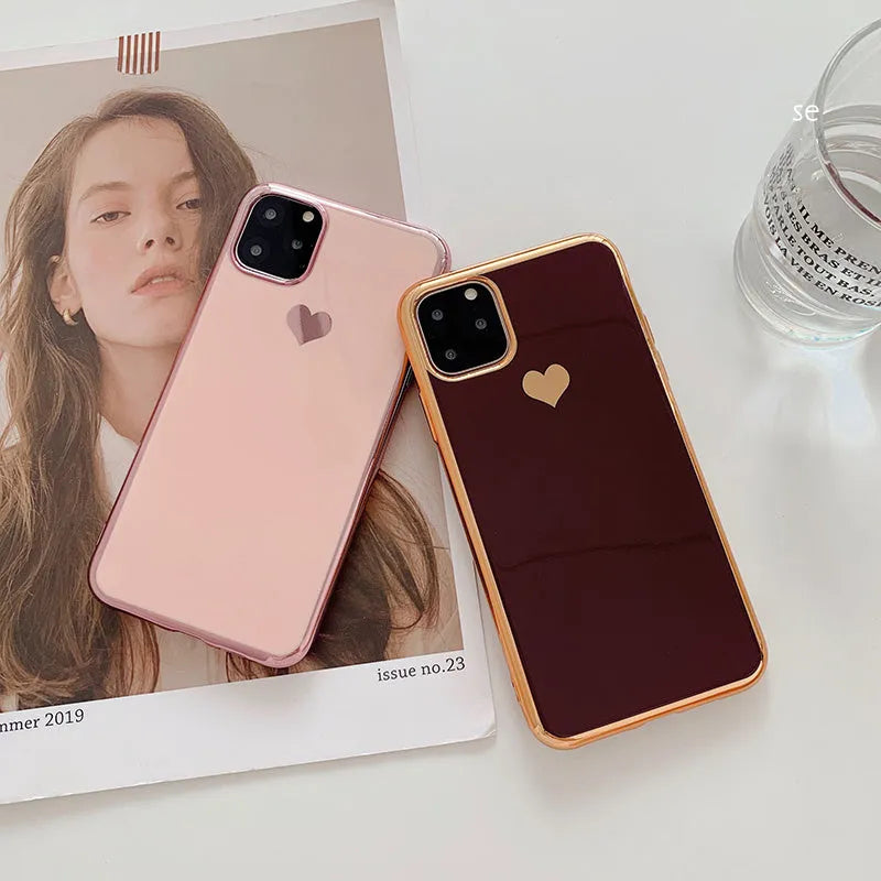 TPU iPhone case with solid colour and a raised metallic love heart design on the back.