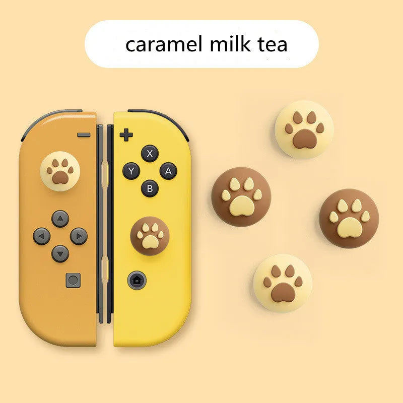 Four silicone rocker caps for Nintendo Switch Joy-Con controllers in assorted colours on a grey background.