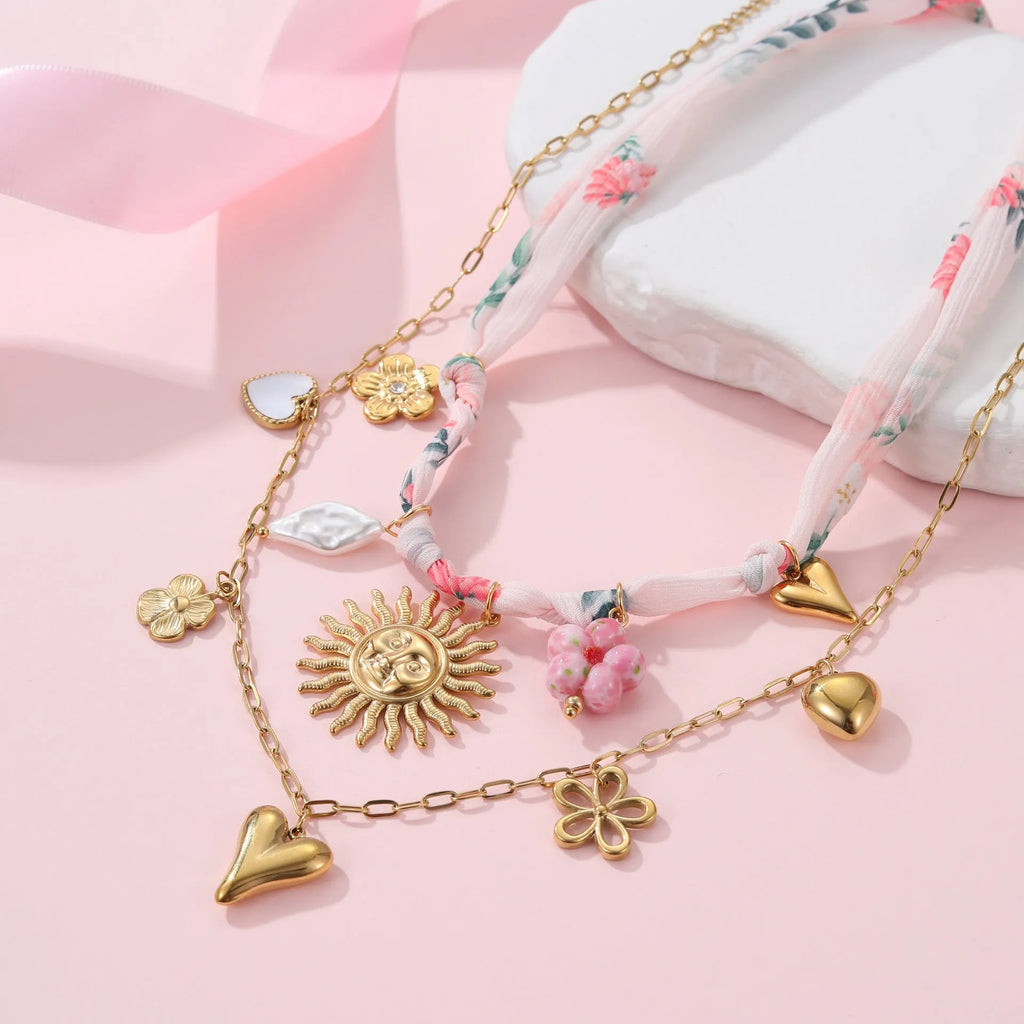 Stainless steel necklace with 18K gold electroplating and a geometric pendant, shown on a regular chain.