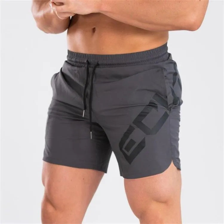Man wearing black knee-length nylon running shorts during summer training.