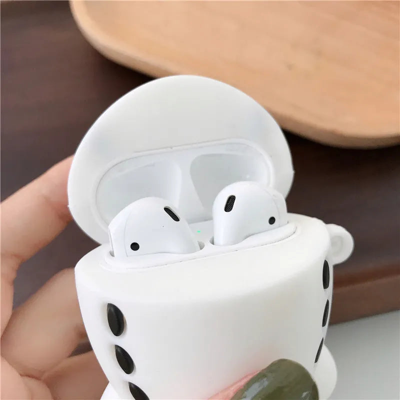 Silicone AirPods protective case with flip-top design, cartoon airplane graphics, and integrated carrying hook