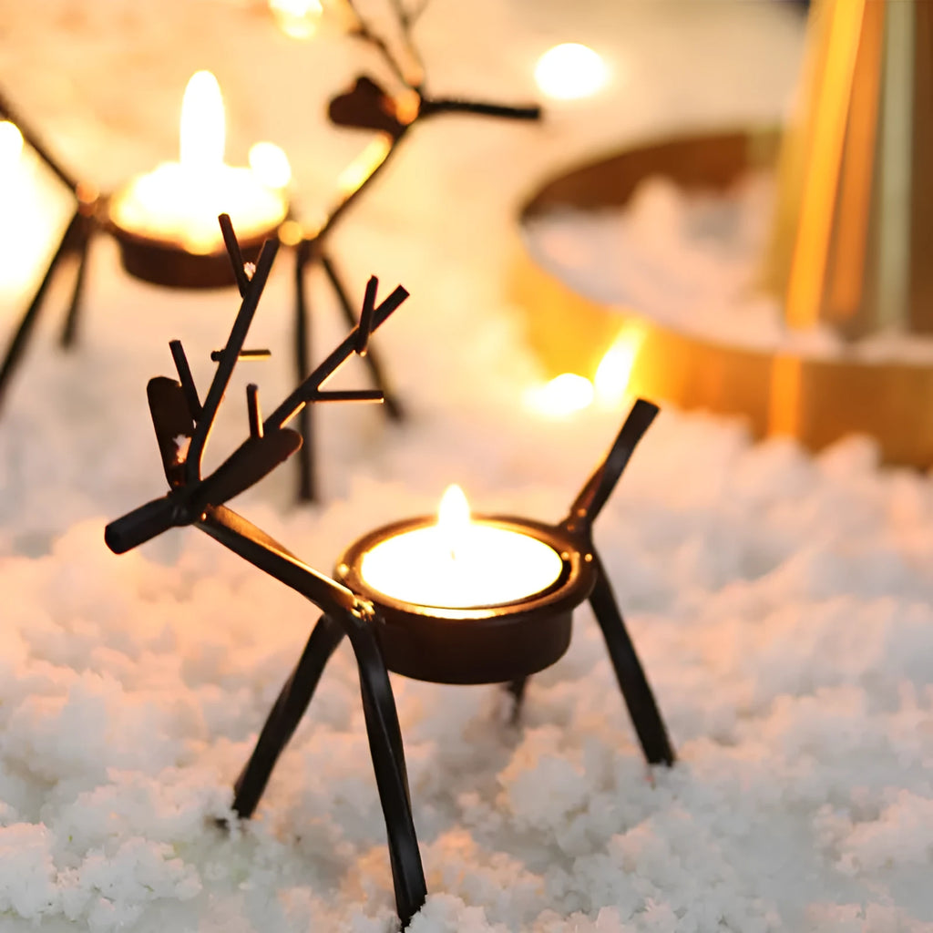 Black iron Christmas candlestick holder with decorative elk antler design.
