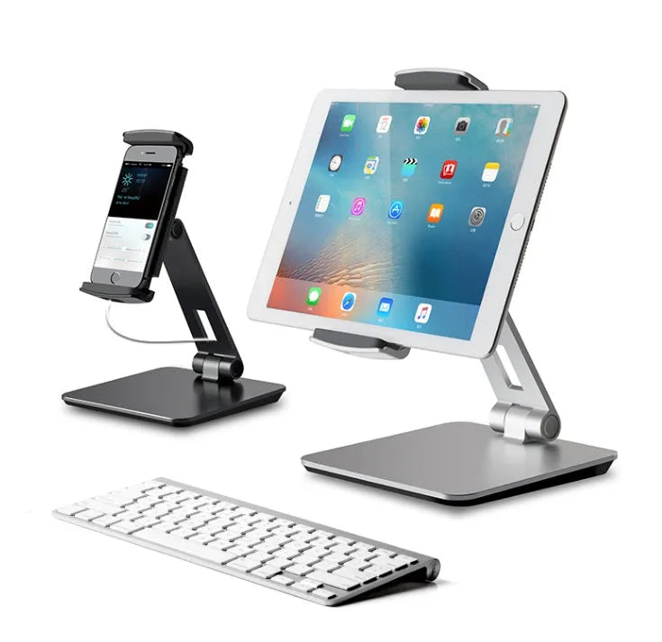 Silver foldable aluminium stand holding a tablet at an angle on a desk