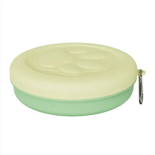 Portable dog feeding bowl with snack compartment lid in light green colour