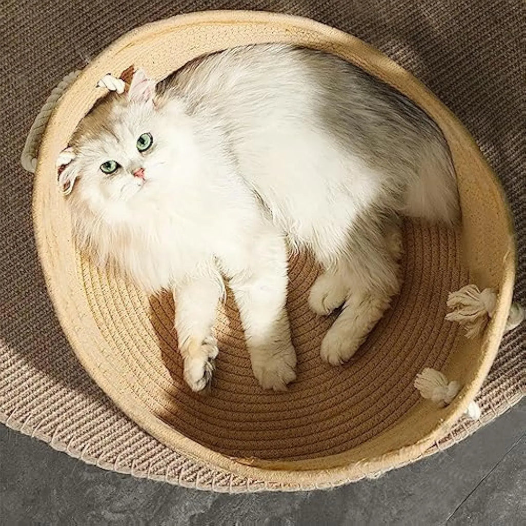 Wicker cat basket bed with a built-in corrugated cardboard scratching panel.