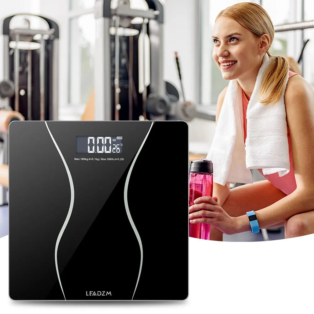Black electronic bathroom scale with digital display showing weight measurement up to 180kg