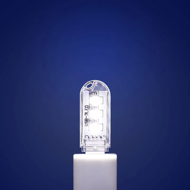 Small white USB-powered LED baby night light on a table