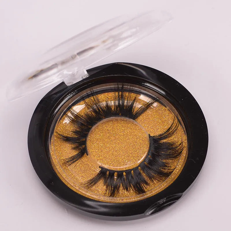 A pair of handmade 5D false eyelashes made from mink hair, shown with a double-headed brush and a hair cap.