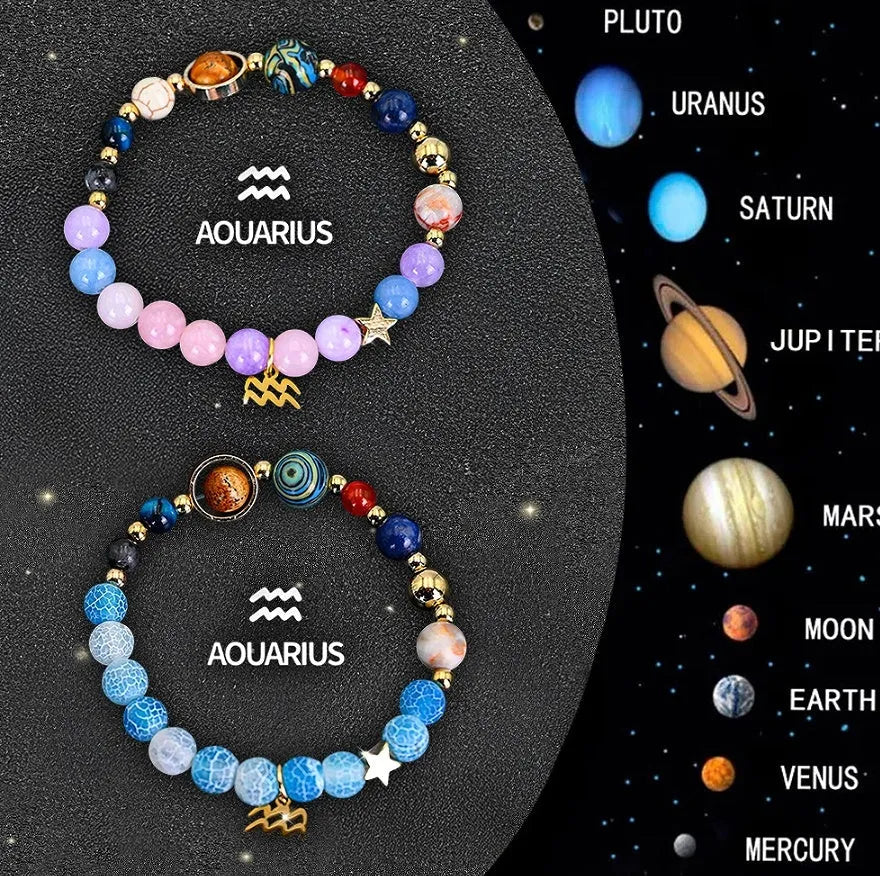 Two adjustable natural stone beaded bracelets with metal zodiac sign charms on a wooden surface.